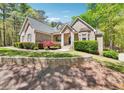 Charming brick home featuring a well-manicured lawn and mature landscaping at 45 Harvey Ave, Covington, GA 30016