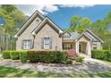 Charming brick home featuring a well-manicured lawn and mature landscaping at 45 Harvey Ave, Covington, GA 30016