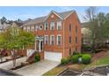Beautiful brick townhome with lush landscaping, attached garage and an inviting front entrance with stairs at 4880 Payson Se Ter, Atlanta, GA 30339