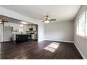 Open-concept living room with hardwood floors connects seamlessly to a modern kitchen at 6497 King William Dr, Morrow, GA 30260
