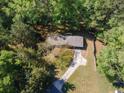 Aerial view of the home showcasing the roof, driveway, and surrounding trees at 125 Valley View Ct, Tyrone, GA 30290