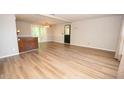 Open concept living room with hardwood floors and access to the back deck at 125 Valley View Ct, Tyrone, GA 30290