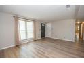 Bright living room featuring new floors, neutral paint, and large window at 125 Valley View Ct, Tyrone, GA 30290
