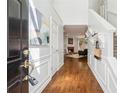 Welcoming foyer with hardwood floors, wainscoting, and views into the living room at 1433 Chardin Dr, Marietta, GA 30062