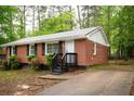 This charming brick home features a concrete driveway and manicured landscaping at 4322 Glenwood Pkwy, Decatur, GA 30032