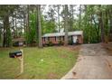 Lovely brick home with mailbox and ample parking space, nestled in a wooded area at 4322 Glenwood Pkwy, Decatur, GA 30032