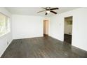 Spacious living room with ceiling fan, windows and beautiful dark wood flooring at 4322 Glenwood Pkwy, Decatur, GA 30032