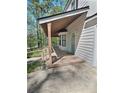 Inviting covered porch with wood decking and railings, offering a relaxing outdoor space at 4460 Branchwood Ct, Loganville, GA 30052
