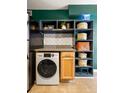 A kitchenette features a stacked washer/dryer combo, shelving, granite countertops, and a stainless steel refrigerator at 1355 Euclid Ne Ave # 15A, Atlanta, GA 30307