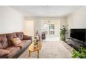 Bright living room with a large window and neutral tones creating a welcoming space at 233 Cobblestone Trl, Avondale Estates, GA 30002