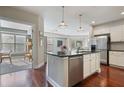 Open concept kitchen with stainless steel appliances, island and view to the living area at 200 River Vista Dr # 423, Atlanta, GA 30339