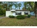 Inviting home with a well-maintained front lawn, showcasing its classic architecture and welcoming entrance at 3074 Delowe Dr, Atlanta, GA 30344