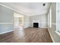 Bright living room with a fireplace, new wood floors, and natural light from large windows at 3455 Kingsbrooke Way, Decatur, GA 30034
