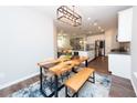 Beautiful dining room featuring an unique table and bench seating, positioned near the modern, open-concept kitchen at 3495 Delegate Aly, Scottdale, GA 30079