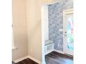 Stylish entryway with built-in bench, patterned wallpaper, and access to the outdoors at 3495 Delegate Aly, Scottdale, GA 30079