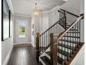 Elegant foyer with hardwood floors, staircase and natural light from the front door at 74 Academy St, Alpharetta, GA 30009