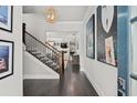 Welcoming foyer features hardwood floors, elegant staircase, and stylish decor at 74 Academy St, Alpharetta, GA 30009