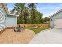 Backyard features a stone patio, manicured lawn and a fire pit at 2374 Marion Cir, Decatur, GA 30032