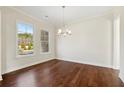 Well-lit dining area with hardwood floors and large windows at 5827 Creek Indian Dr, Sugar Hill, GA 30518