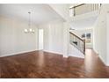 Bright and airy living room with hardwood floors and staircase at 5827 Creek Indian Dr, Sugar Hill, GA 30518