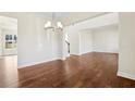 Open-concept living space with hardwood floors and modern lighting at 5827 Creek Indian Dr, Sugar Hill, GA 30518