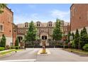 View of elegant townhomes behind wrought-iron gates and mature trees at 1276 Edmund Ne Ln, Brookhaven, GA 30319