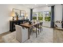 Elegant dining room featuring a wooden table with seating for six, with a view of the lush green landscape at 1407 Bluffs Ridge Way, Canton, GA 30114