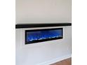 Electric fireplace with a sleek black mantle, set in a bright white wall at 2610 Knoll Se Rd, Smyrna, GA 30080