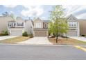 Street view of three craftsman homes in a neighborhood setting, with well-kept lawns and driveways at 275 Denver Ave, Hiram, GA 30141