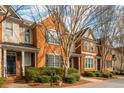Beautiful brick townhome showcasing detailed architecture, complemented by lush greenery and a cozy entrance at 4735 Longcourt Se Dr, Atlanta, GA 30339