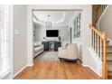 Open-concept living room features hardwood floors, coffered ceilings, and a stylish entertainment center at 4735 Longcourt Se Dr, Atlanta, GA 30339