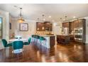 Spacious kitchen with dark wood cabinetry, stainless steel appliances, and a breakfast bar at 1023 Bentley Estates Dr, Dacula, GA 30019