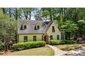 Charming home with dormer windows, stone accents, and a well-maintained lawn at 1711 Homestead Ne Ave, Atlanta, GA 30306