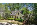 Charming home nestled among mature trees, featuring dormer windows and stone accents at 1711 Homestead Ne Ave, Atlanta, GA 30306