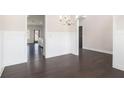 Spacious dining area boasting stylish wainscoting, modern chandelier, and sleek hardwood floors at 1600 Kamp Springs Ave, Lawrenceville, GA 30045