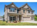 Charming two-story home with brick and siding exterior, front lawn, and three-car garage at 1600 Kamp Springs Ave, Lawrenceville, GA 30045