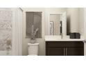 Stylish bathroom with modern fixtures, dark wood vanity, white marble countertop and a shower-tub combo at 2450 Cotton Ln, Douglasville, GA 30135
