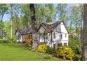 Exterior view of a charming home with white siding, brown trim, and a well-maintained lawn at 639 Ladora Dr, Dallas, GA 30157