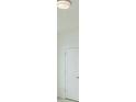 Bright hallway with a five-panel door and recessed lighting at 6585 Rhett Run, Cumming, GA 30028