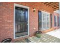 Inviting front entrance featuring a black door with decorative hardware and a manicured garden at 392 Mill Pond Cossing, Carrollton, GA 30116