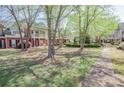A serene community lawn with mature trees and well-maintained landscaping at 392 Mill Pond Cossing, Carrollton, GA 30116