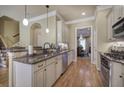 Elegant kitchen featuring granite countertops, stainless steel appliances, and hardwood floors at 636 Parkside Village Nw Way, Marietta, GA 30060