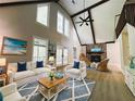 Bright living room boasts vaulted ceilings, hardwood floors, and lots of natural light at 6460 Pine Ridge Cir, Cumming, GA 30041