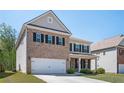 Charming two-story brick and siding home with a well-manicured lawn and an attached two-car garage at 224 Gallant Fox Way, Acworth, GA 30102