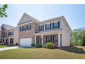 Charming two-story brick and siding home with a well-manicured lawn and an attached two-car garage at 224 Gallant Fox Way, Acworth, GA 30102