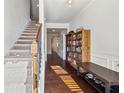 Welcoming entryway showcasing hardwood floors, staircase, and built-in shelving for storage and decor at 4565 Grenadine Cir, Acworth, GA 30101