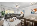 Cozy living room featuring a comfortable sectional sofa, large windows, and stylish decor at 4565 Grenadine Cir, Acworth, GA 30101