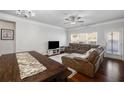 Inviting living room with hardwood floors, a comfortable sofa, and a view of the backyard at 4565 Grenadine Cir, Acworth, GA 30101