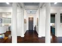 Inviting foyer with dark wood floors, white columns, and views of kitchen and living spaces at 77 Peachtree Ne # 507, Atlanta, GA 30309