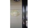Close-up of front door with historic plaque and modern smart lock at 1168 Eggleston Sw St, Atlanta, GA 30310